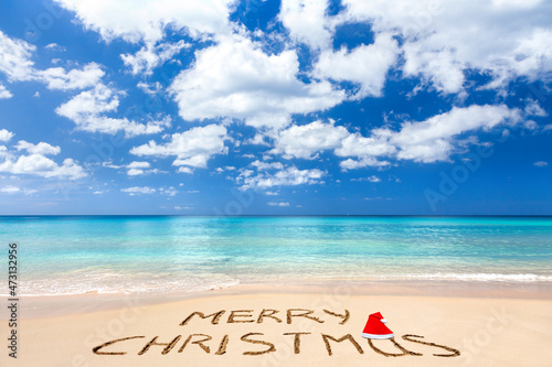 Merry Christmas written on a sandy beach