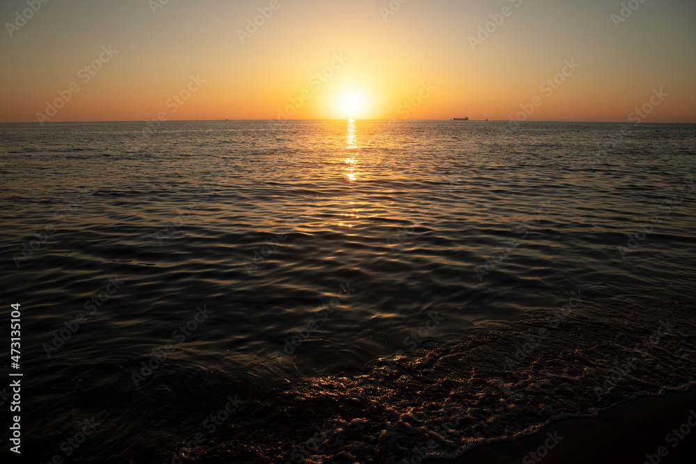 Bright sun at sunset on the sea.
