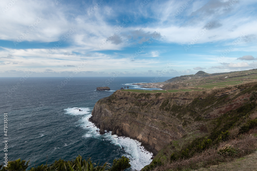 Seascape. cliffs in the west of Sao Miguel with Mosteiros town in the background. Azores. Portugal
