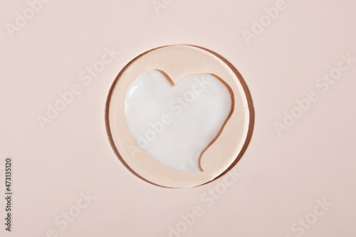 Swatch of cosmetic cream in form of heart.Pastel background,good as mockup.