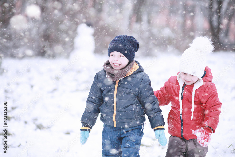 Kids walk in the park first snow Kids walk in the park first snow