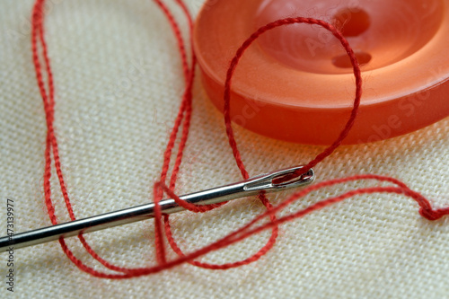 Red button with a needle