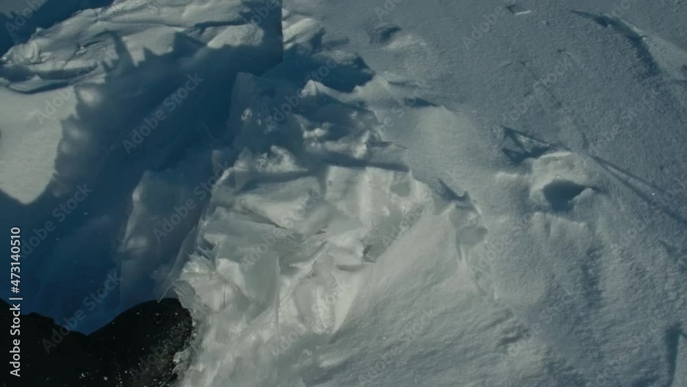 A man walks on snowy ice. The boot kicks the snow. Beautiful winter landscape. Natural landmark of Russia. Top view. Slow motion. A man walks on snowy ice. The boot kicks the snow. Beautiful winter landscape. Natural landmark of Russia. Top view. Slow motion.