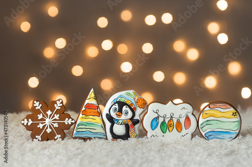 Christmas cute set of cinnamon gingerbread cookies for kids on background of garlands warm bokeh lights 
