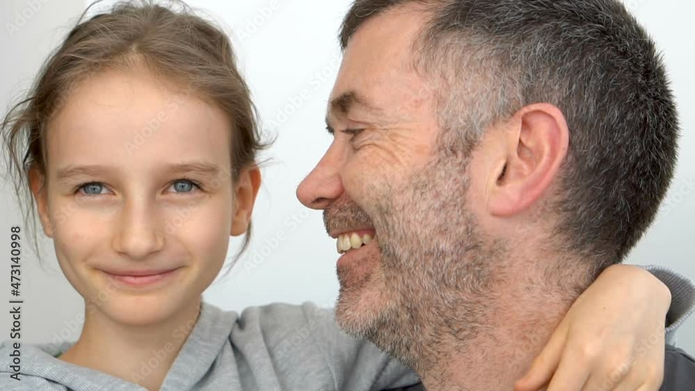 Family portrait of senior father and little blond daughters are hugging indoors and smiling, fathers day celebration concept Family portrait of senior father and little blond daughters are hugging indoors and smiling, fathers day celebration concept