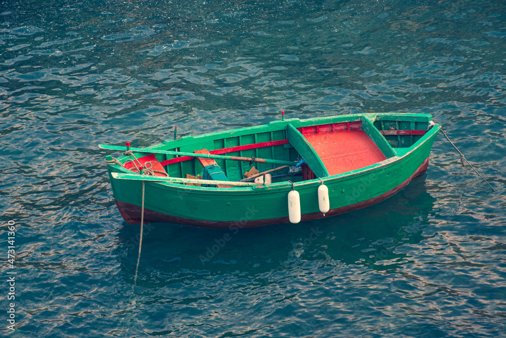 Beautiful old colored fishing wooden boat on the water