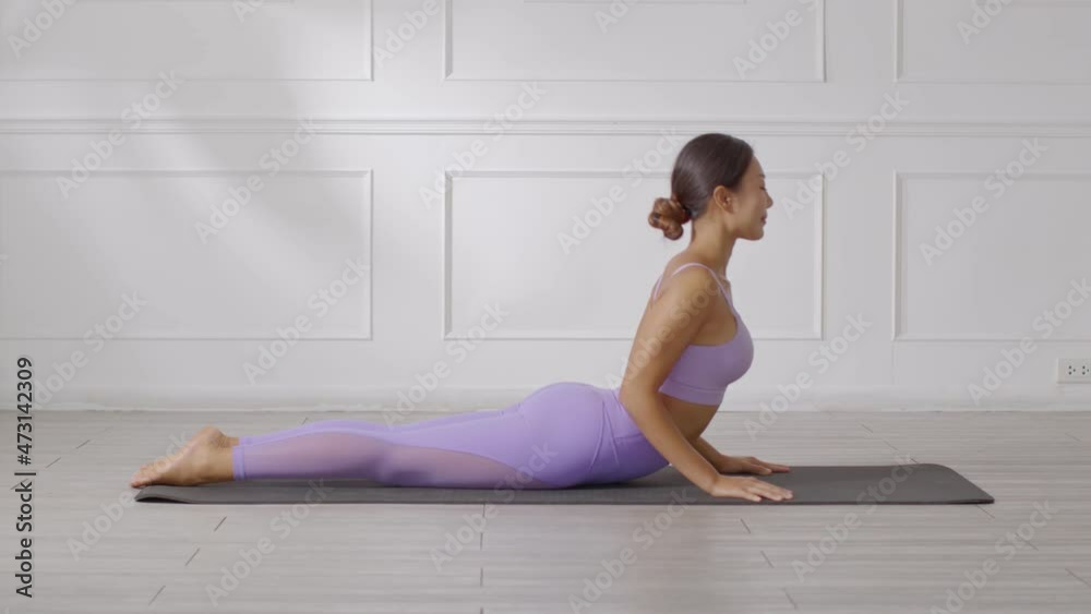 Wellness Attractive Asian woman in purple wear doing yoga Cobra pose at home to meditation comfortable and relax,Calm of healthy young woman deep breath and meditation with yoga at home,Yoga Concept Wellness Attractive Asian woman in purple wear doing yoga Cobra pose at home to meditation comfortable and relax,Calm of healthy young woman deep breath and meditation with yoga at home,Yoga Concept