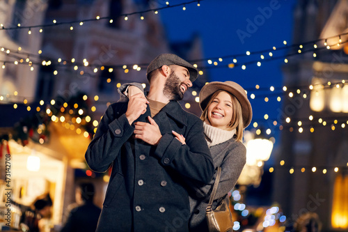 Canvas Print Romantic Christmas couple laughing outdoors on Christmas eve