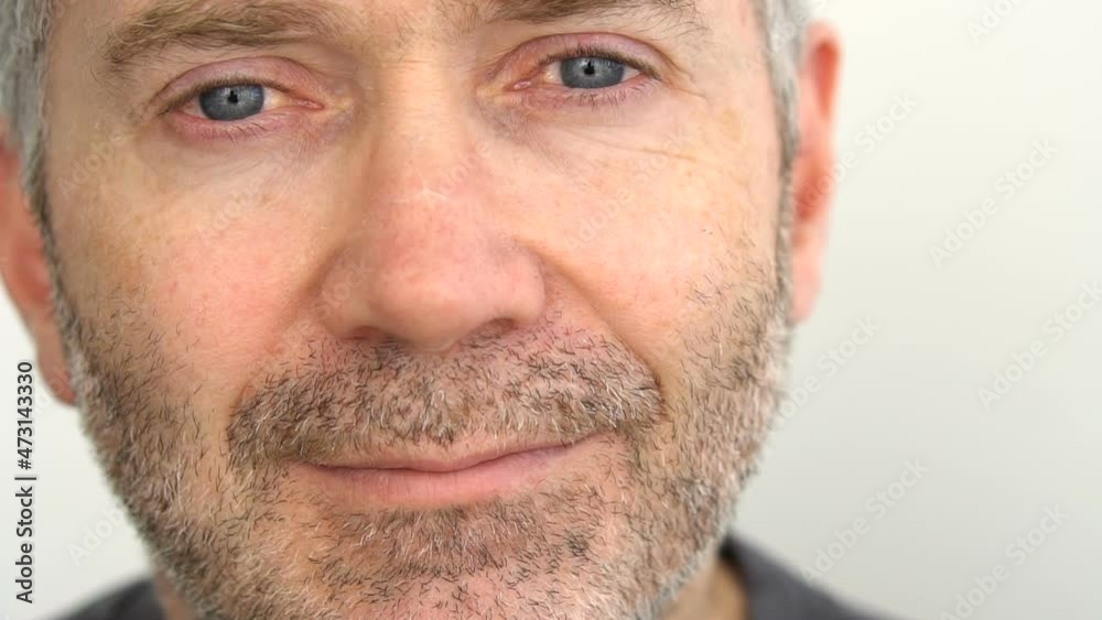 Close-up portrait of senior man with blue eyes and grey beard on white wall background, fathers day concept Close-up portrait of senior man with blue eyes and grey beard on white wall background, fathers day concept