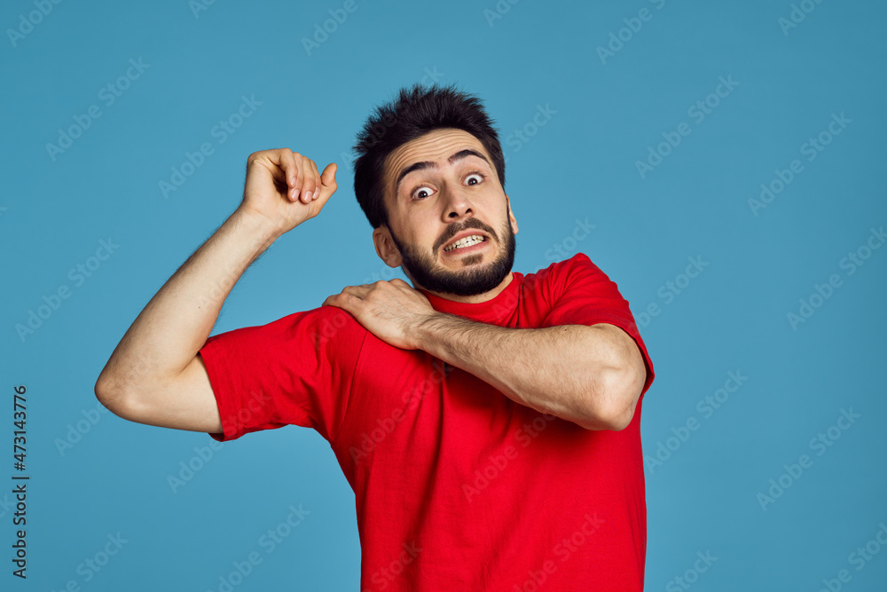 man in red t-shirt health problems emotions symptoms blue background man in red t-shirt health problems emotions symptoms blue background