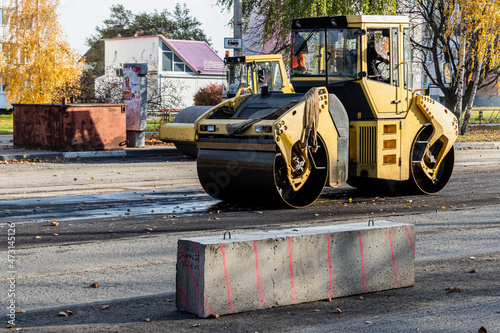 Heavy duty vibratory road roller for asphalt concrete works and road repairs. Heavy machinery when repairing asphalt pavement. photo