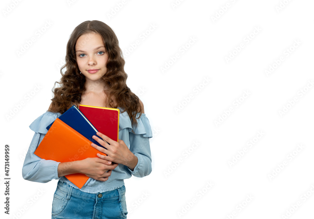 Happy teenager student girl is holding colored books and notepads. Smiling schoolgirl isolated on white. Concept of education, reading, back to school Happy teenager student girl is holding colored books and notepads. Smiling schoolgirl isolated on white. Concept of education, reading, back to school