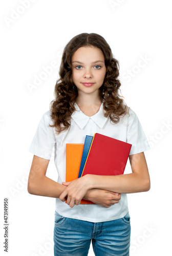 Happy cute student girl in school uniform holding books. Smiling schoolgirl isolated on white. Concept of education, reading, back to school