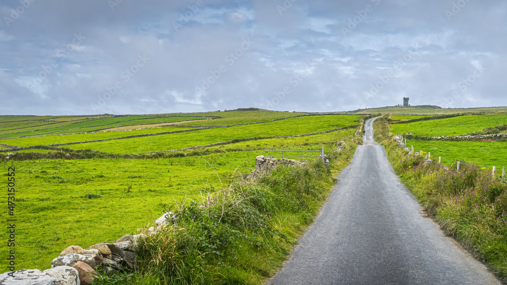 Obraz premium Country road leading to Moher Tower at Hags Head in Cliffs of Moher, popular tourist attraction, Wild Atlantic Way, County Clare, Ireland