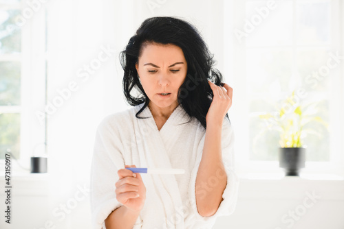 Abortion concept. Caucasian middle-aged mature woman feeling shock frustration because of positive negative fertility pregnancy test result
