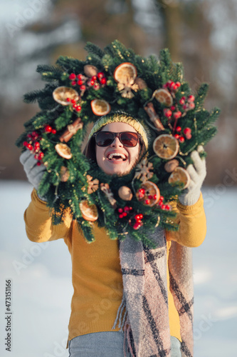 Fototapeta Naklejka Na Ścianę i Meble -  Woman with handmade Christmas wreaths on winter background