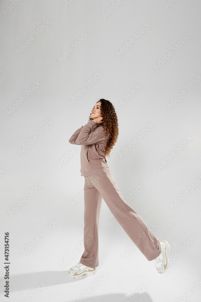 Fototapeta premium Young woman in trendy casual clothes posing on the white background