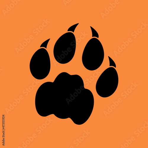 Vector silhouette of a paw of a wild animal. Paw print with claws. Footprints of a big cat or forest animal on an isolated orange background. Tiger, lion or bear.