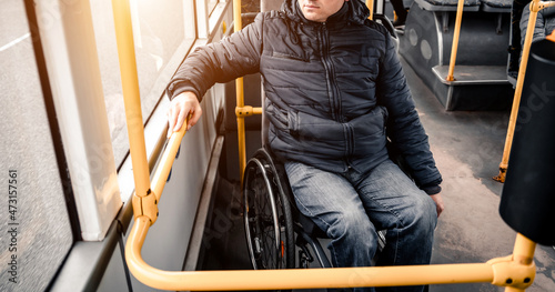 Person with a physical disability inside public transport with an accessible ramp. photo