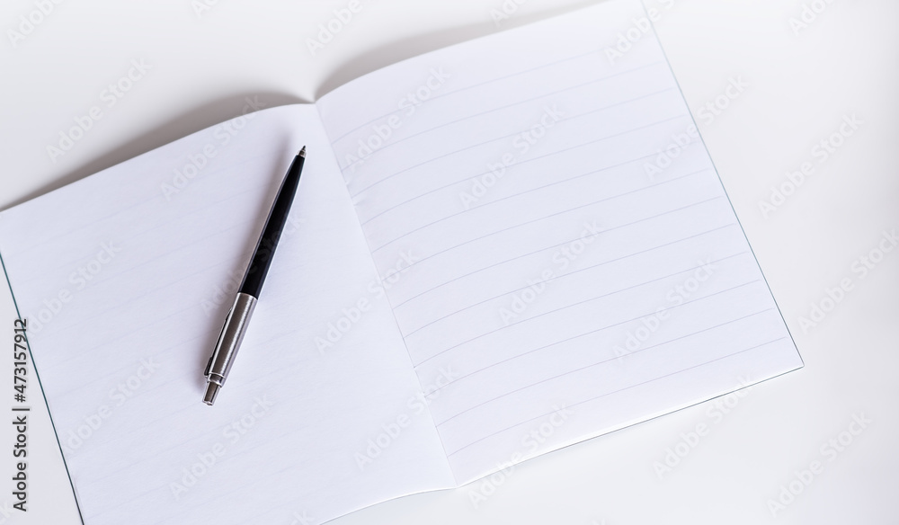 blank white booklet with pen on white background. Copy space. blank white booklet with pen on white background. Copy space.