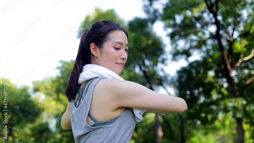 Beautiful Asian woman exercising in the park in the morning. concept of healthy body health care Beautiful Asian woman exercising in the park in the morning. concept of healthy body health care