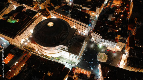 Aerial drone night shot of iconic masterpiece ancient temple of Pantheon in Piazza della Rotonda, Rome historic centre, Italy
