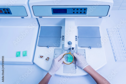 Laboratory assistant works at paraffin wax dispenser tissue embedding machine Fototapet