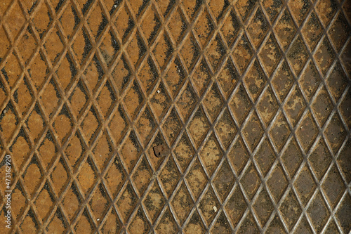 Rusty grid metal sheet textured background.