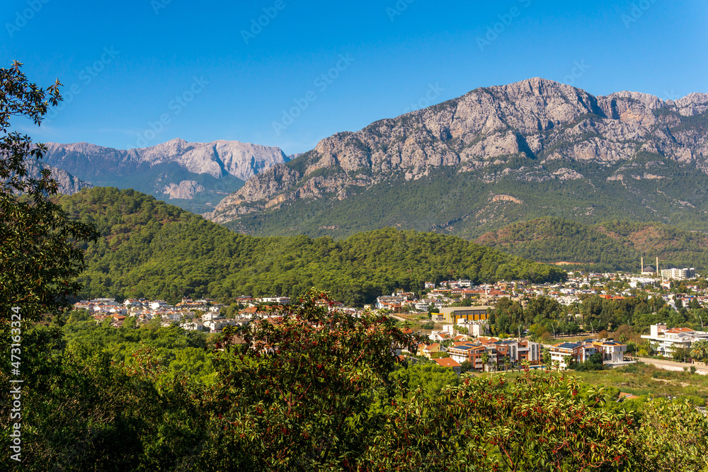 view and of the town in a mountain valley (Kemer, Turkey) with Mount Tahtali (Lycian Olympus) in the distance