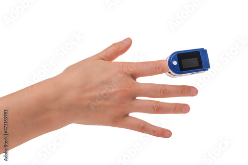 Pulse oximeter on a finger on a white background.