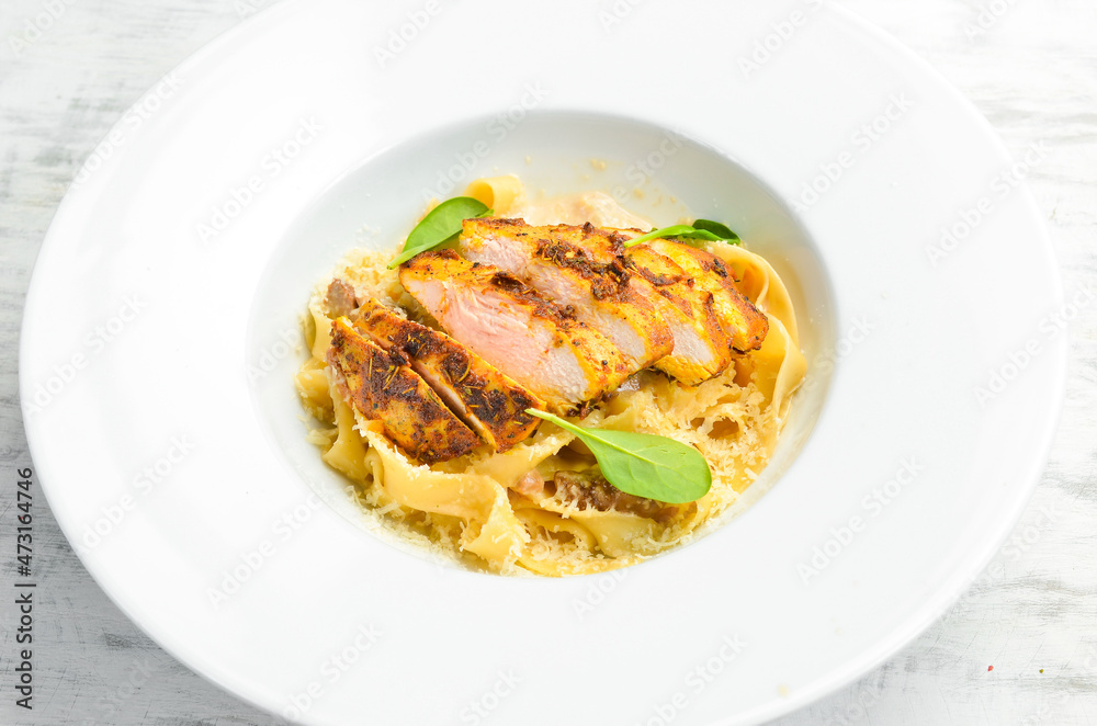 Pasta with chicken fillet, cheese and spinach. Italian cuisine. Menu. Top view.