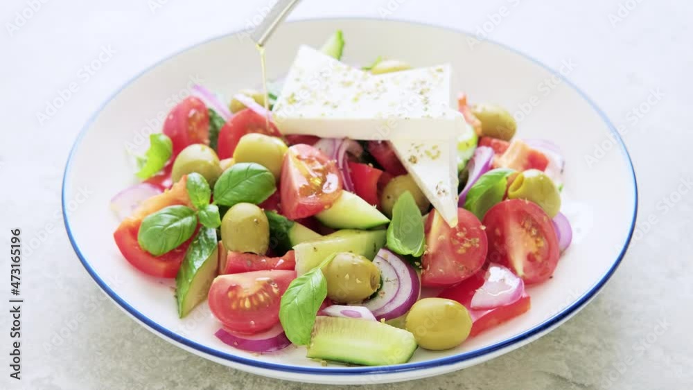 Greek or horiatiki salad with fresh vegetables and feta cheese, dressed with olive oil, traditional Greek cuisine salad