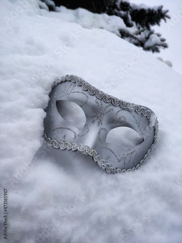 masquerade mask in the snow with selective focus 