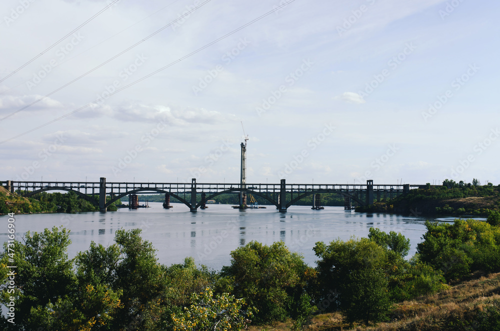 Ukraine, Zaporozhye. View of the blue Dnieper river with rocks, green hills. Khortytsya Island. Center of Ukrainian Cossacks. Dam Dneproges. 