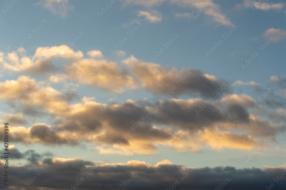 Cloudscape at dusk with gathering cumulus clouds.