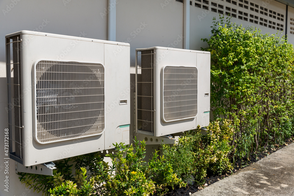 Air conditioner compressor installed in old building. Outdoor split ...