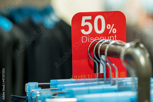 Closeup sale 50% discount mock up advertise display frame setting over the clothes line in the shopping department store for shopping, business fashion and advertisement concept