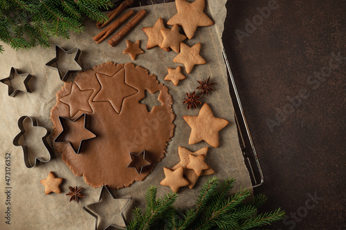 Christmas gingerbread dough in the cooking process on a dark background. top view