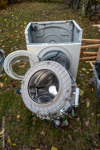 Pile of home bulky waste as wash machine prepared for pickup at the street in German city. photo