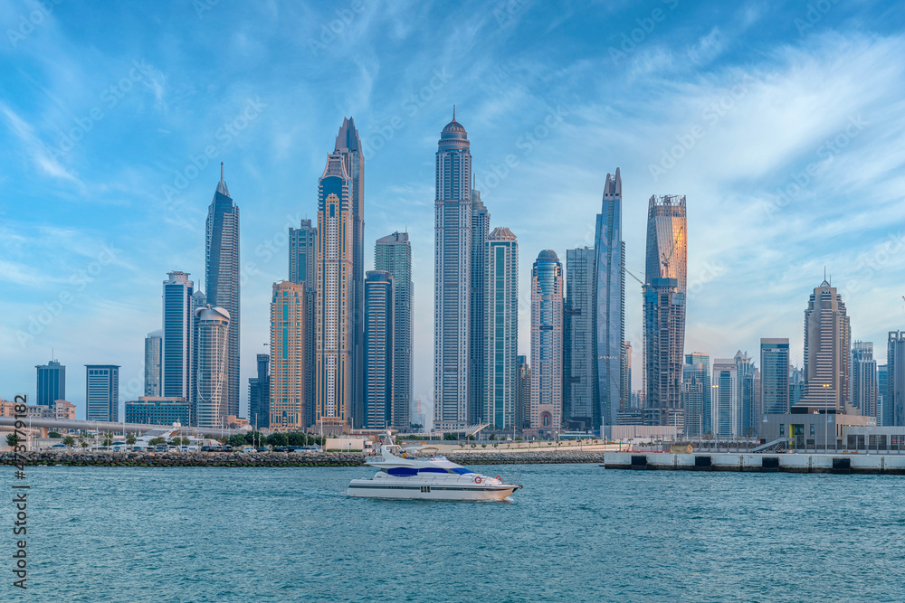 Fototapeta premium Scenic view of Dubai Marina Skyscrapers with big boat, Skyline, View from Palm Beach, United Arab Emirates
