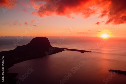 Colorful warm sunset and Le Morn mountain with ocean in Mauritius. Aerial view