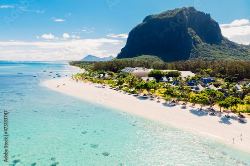 Fototapeta Naklejka Na Ścianę i Meble -  Luxury tropical beach and Le Morne mountain in Mauritius. Beach with coconut palms and transparent ocean. Aerial view