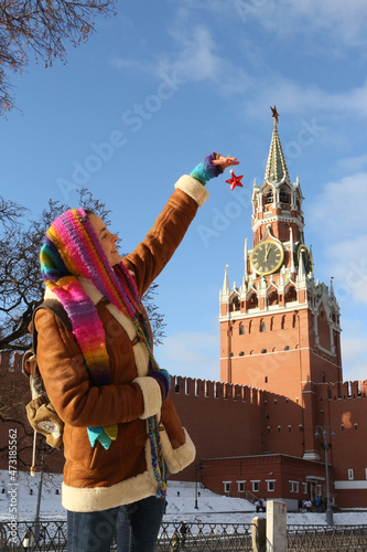 Tourist woman, tourist girl on Red Square near Spasskaya Tower, Kremlin, Moscow city, Russia. Moscow landmark, monument. Moscow Kremlin, architecture. Tourist people. Travel, tourism in Mocow, Russia photo