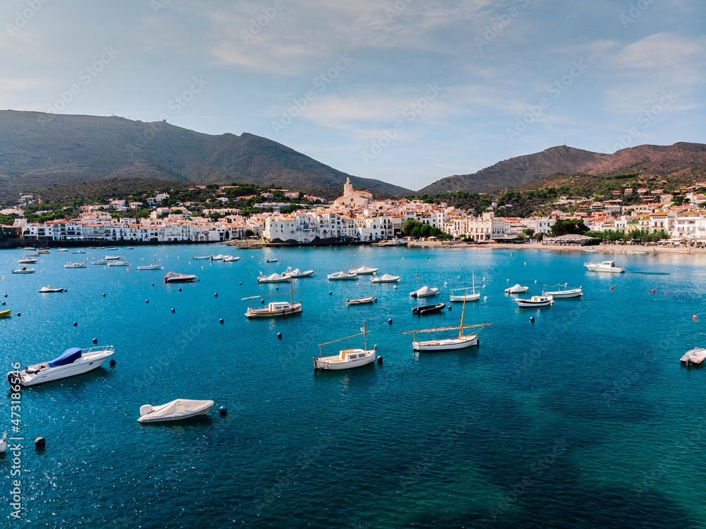 Drone shot Santa Maria de Cadaqués Drone view of a small village on the Costa Brava in Cadaqués. Boats in a rocky bay in Cadaques. View from the drone of the beach and the bay in Cadaques. Drone shot Santa Maria de Cadaqués Drone view of a small village on the Costa Brava in Cadaqués. Boats in a rocky bay in Cadaques. View from the drone of the beach and the bay in Cadaques.