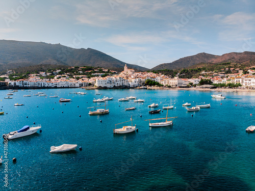 Drone shot Santa Maria de Cadaqués Drone view of a small village on the Costa Brava in Cadaqués. Boats in a rocky bay in Cadaques. View from the drone of the beach and the bay in Cadaques. 