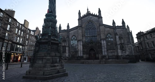 John Knox statue midnight in front of St Giles, a beautiful and historic church in the Old Town of Edinburgh. St Giles Cathedral medieval cathedral in the city located in the heart of the Old Town