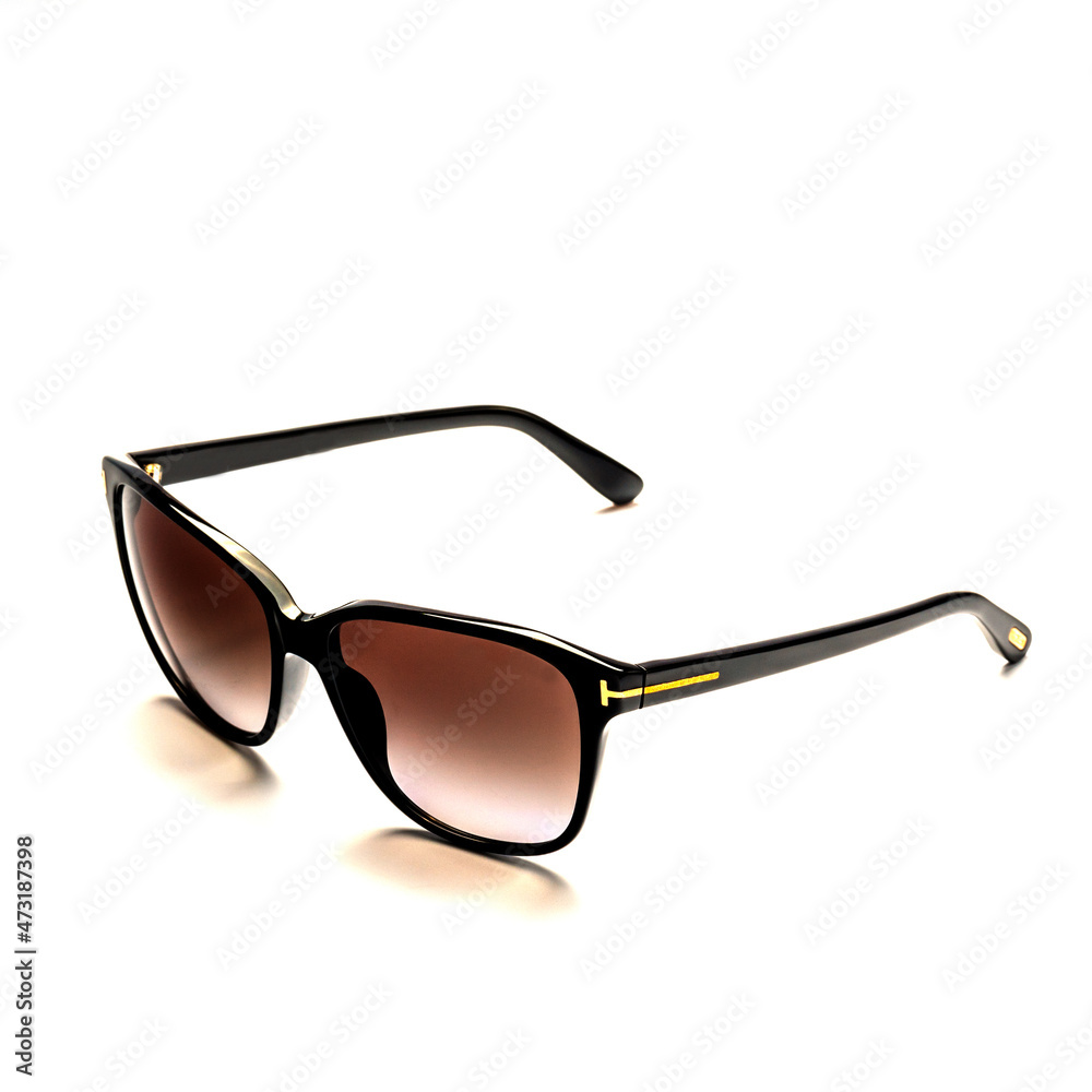 Black, women's sunglasses on a white background close-up. Black, women's sunglasses on a white background close-up.
