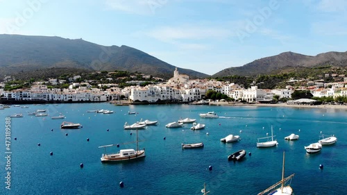 Drone shot Santa Maria de Cadaqués Drone view of a small village on the Costa Brava in Cadaqués. Boats in a rocky bay in Cadaques. View from the drone of the beach and the bay in Cadaques. 