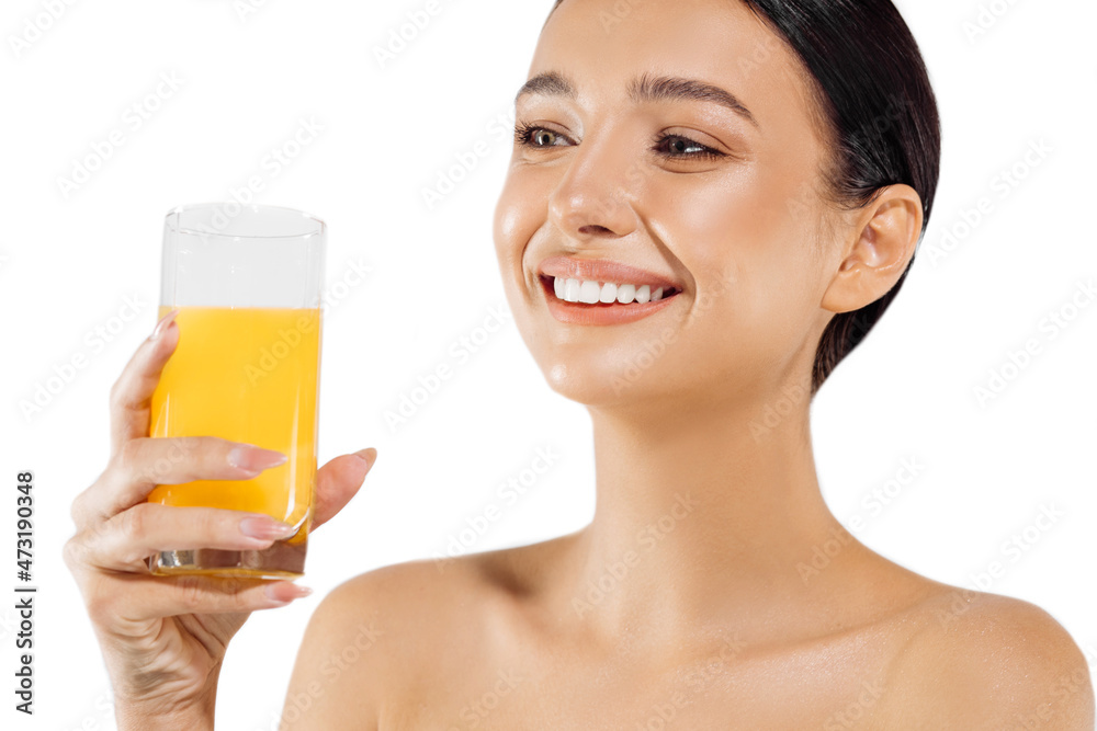 Beautiful young woman with a glass of orange juice drinking fresh orange juice on an isolated white background Beautiful young woman with a glass of orange juice drinking fresh orange juice on an isolated white background