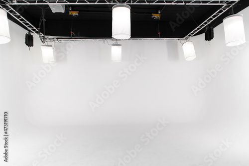 An empty large white photo studio for shooting large objects, cars or people. seamless white cyclorama